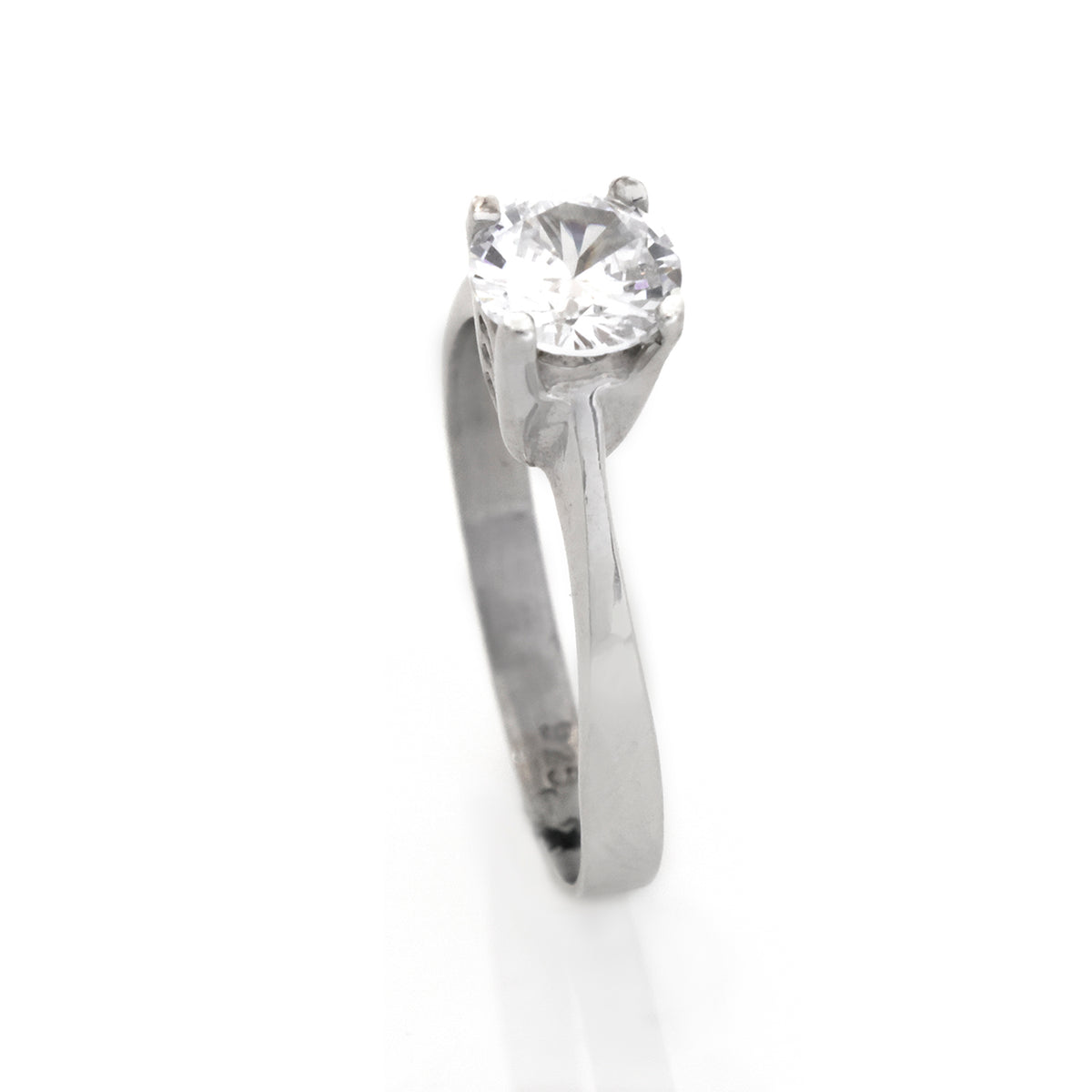 Silver ring with a large diamond on a white background