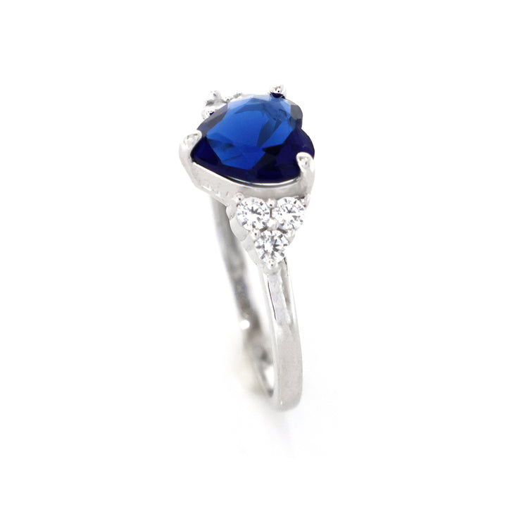 Silver ring with a blue gemstone and small diamonds on a white background