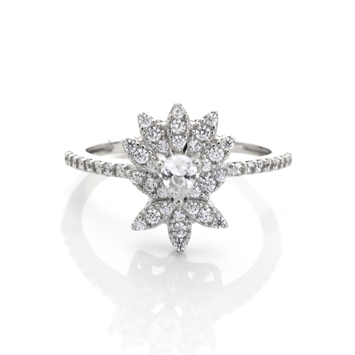 Silver ring with star-shaped diamond cluster on a white background