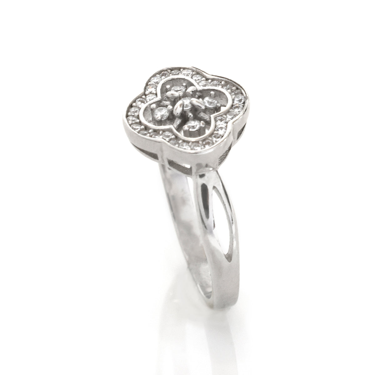 Silver ring with clover design on a white background