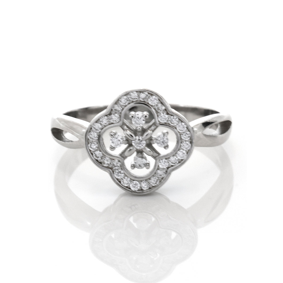 Silver ring with diamond accents on a white background