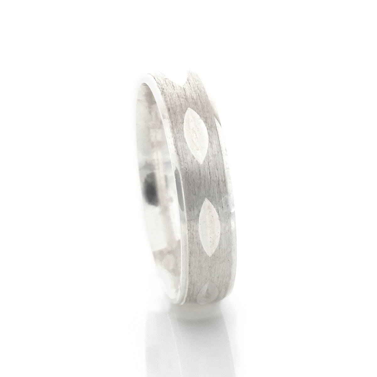 Silver ring with a textured band on a white background