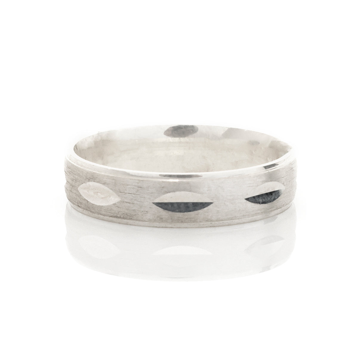Silver ring with engraved design on a white background