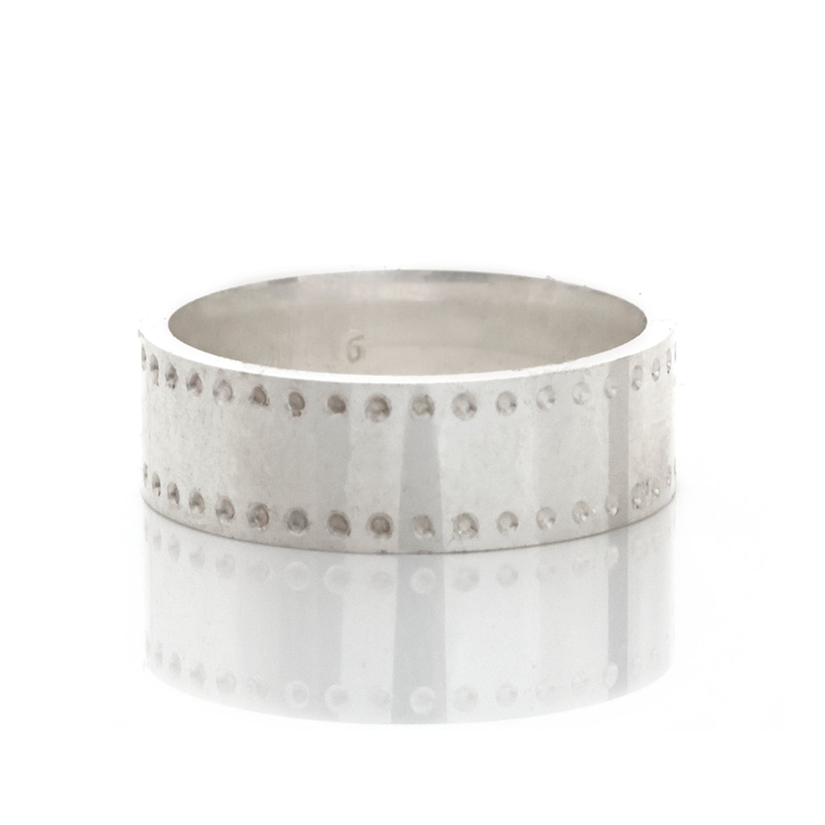 Silver ring with small stones on a white background