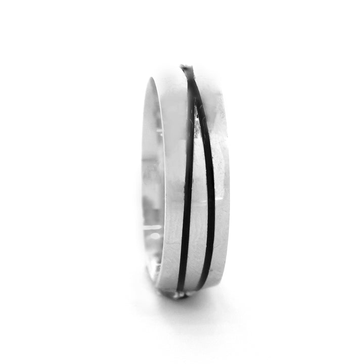 Silver ring with a black stripe on a white background