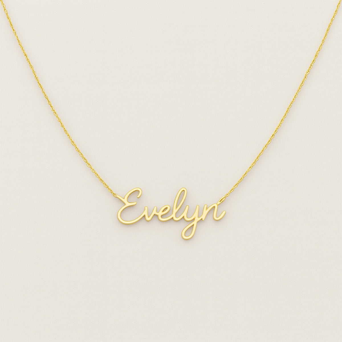 custom gold name necklace with elegant script font on light background